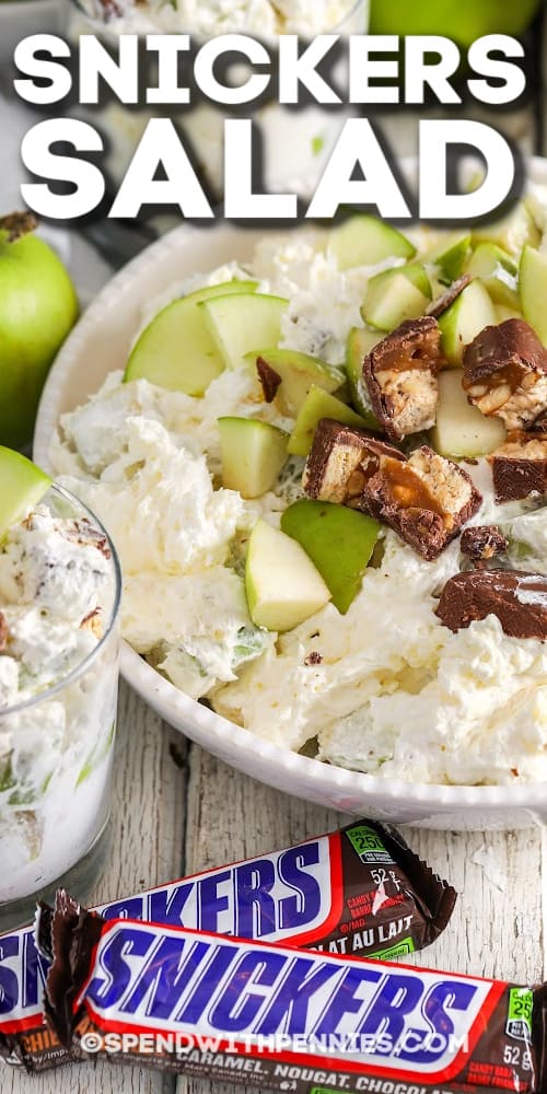 This snicker salad recipe is an easy dessert made with apples, grapes, Snickers & pudding. With just 6 ingredients this dessert salad is quick to prepare. It's perfect to make ahead for your next potluck. picnic, or barbecue. #spendwithpennies #snickersalad #dessert #snickerapplesalad #easy #foracrowd Snickers Salad in a bowl and a glass with text