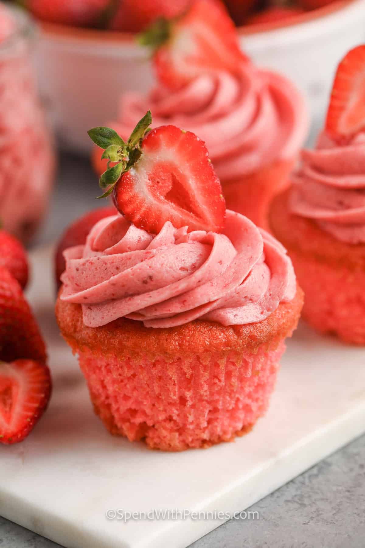 Serve these strawberry cupcakes at the kid's next party or summer BBQ for a sweet treat. Why make things complicated when easy desserts like this strawberry cupcakes recipes can be made with just a few simple ingredients? It will be hard to stop at just one of these moist cupcakes topped with fresh strawberry frosting! #strawberrycupcakes #strawberrycupcakerecipe #cupcake #spendwithpennies cooked Strawberry Cupcakes with frosting