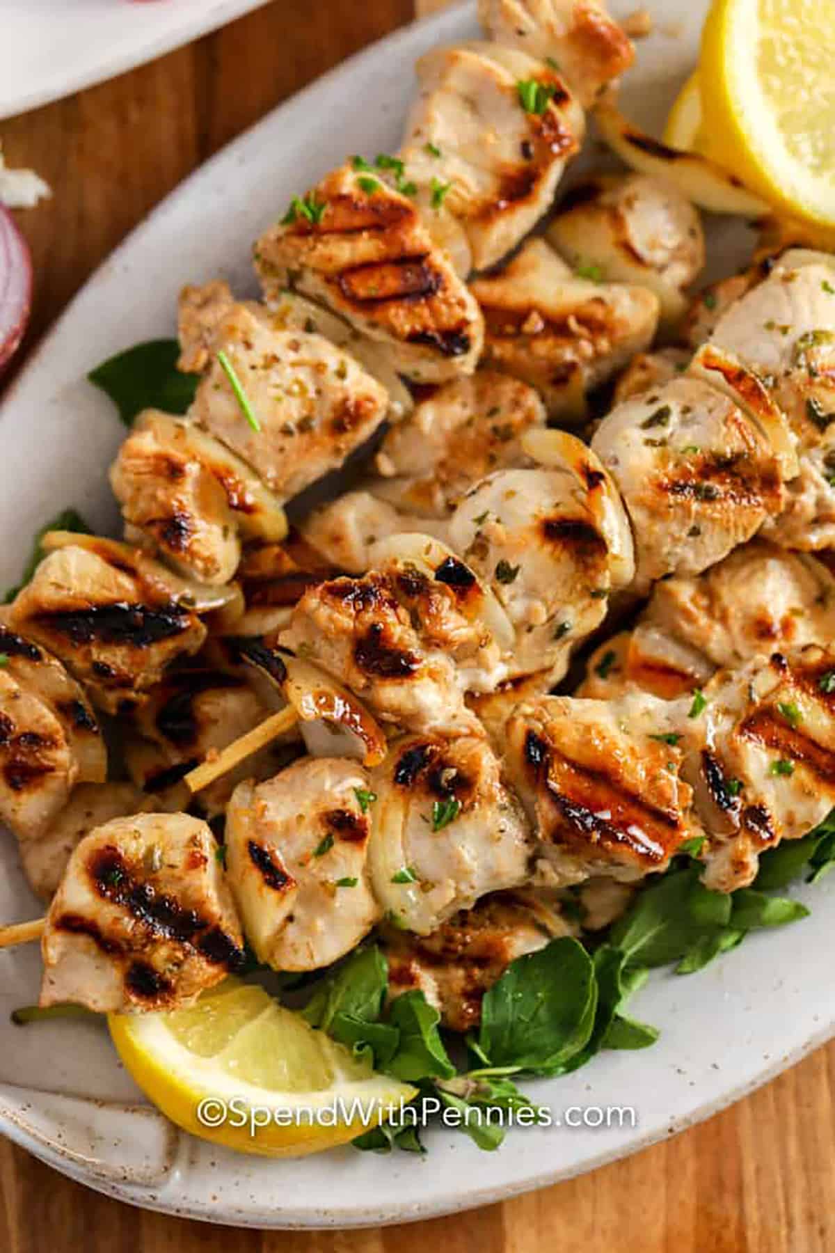 This chicken souvlaki recipe is quick and easy to prepare. Chicken and onions are tossed in a homemade marinade and left to chill for a few hours before being threaded onto a skewer and grilled. #spendwithpennies #souvlaki #chickensouvlaki #greek plated Chicken Souvlaki