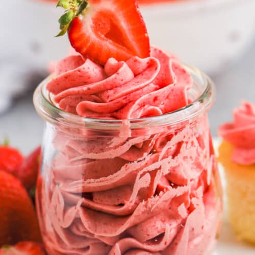 Fresh Strawberry Buttercream in a glass with a strawberry on top
