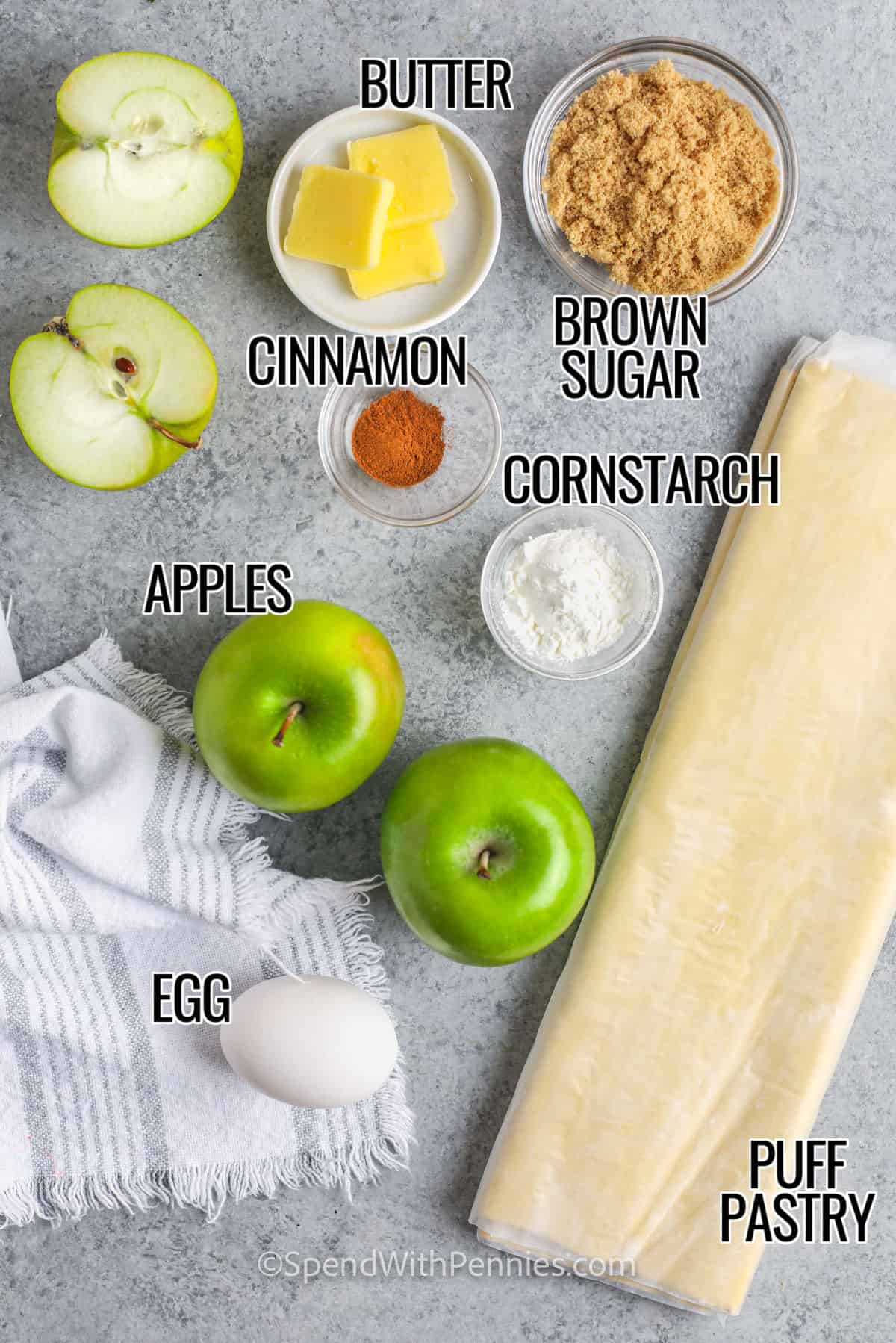 This easy apple turnover recipe is simple to make with puff pastry or even Pillsbury crescent roll dough. A simple and delicious filling is made from scratch using fresh apples and a few other ingredients. Enjoy these tasty little handheld apple pies, fresh from the oven or served cold. #appleturnover #easyappleturnovers #spendwithpennies #withpuffpastry apples , brown sugar , puff pastry , egg , cinnamon , butter and cornstarch to make Easy Apple Turnovers with labels