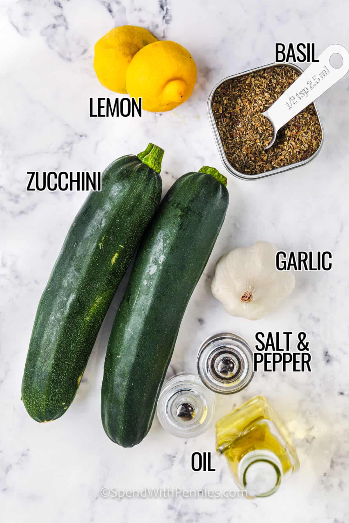 ingredients for grilled zucchini including zucchini, oil, salt, pepper, lemon, basil, and garlic. 