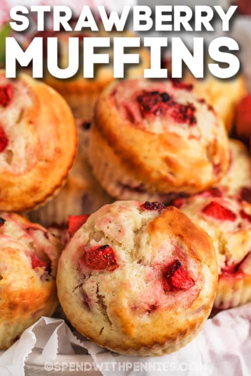 Make these sweet and simple strawberry muffins for dessert. Homemade muffins from scratch are so easy to make. Made with fresh or frozen strawberries, some sour cream for a hint of tanginess, and some vanilla and cinnamon, these muffins are so moist and decadent. Add chocolate, vanilla, cream cheese, or strawberry frosting for the final touch. #strawberrymuffins #easyrecipes #strawberrymuffinrecipe #spendwithpennies bowl of Strawberry Muffins with a title