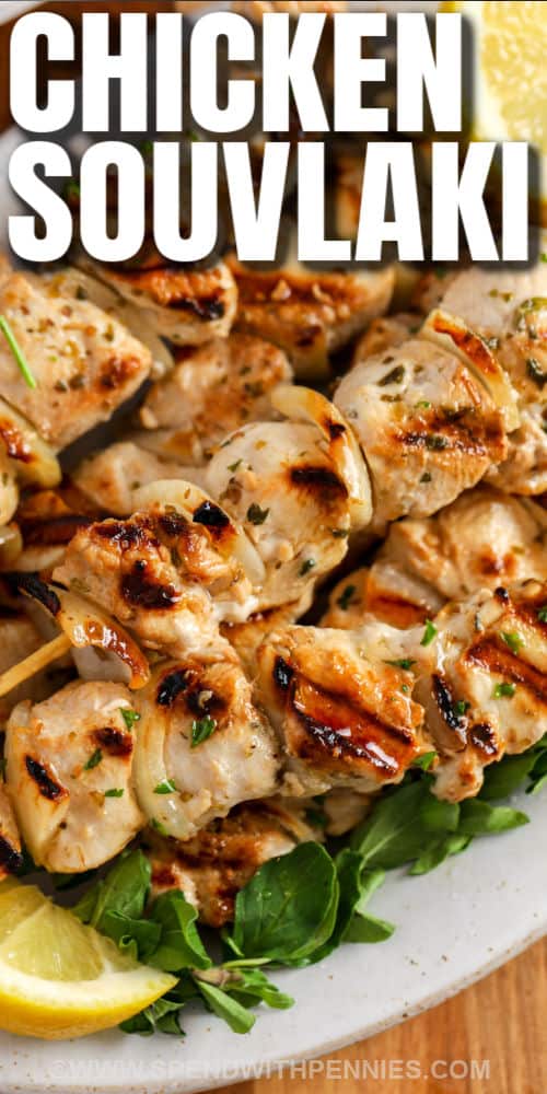 Chicken Souvlaki is a fast and easy meal that is perfect to prep ahead of time! Chicken and onions are tossed in a homemade marinade before being threaded onto a skewer and grilled. #spendwithpennies #souvlaki #chickensouvlaki #greek close up of Chicken Souvlaki with a title