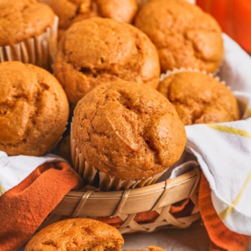 Basket of Easy Pumpkin Muffins with one broken in half