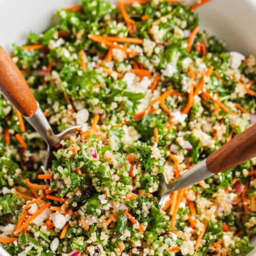 serving Kale Quinoa Salad in a bowl with spoons
