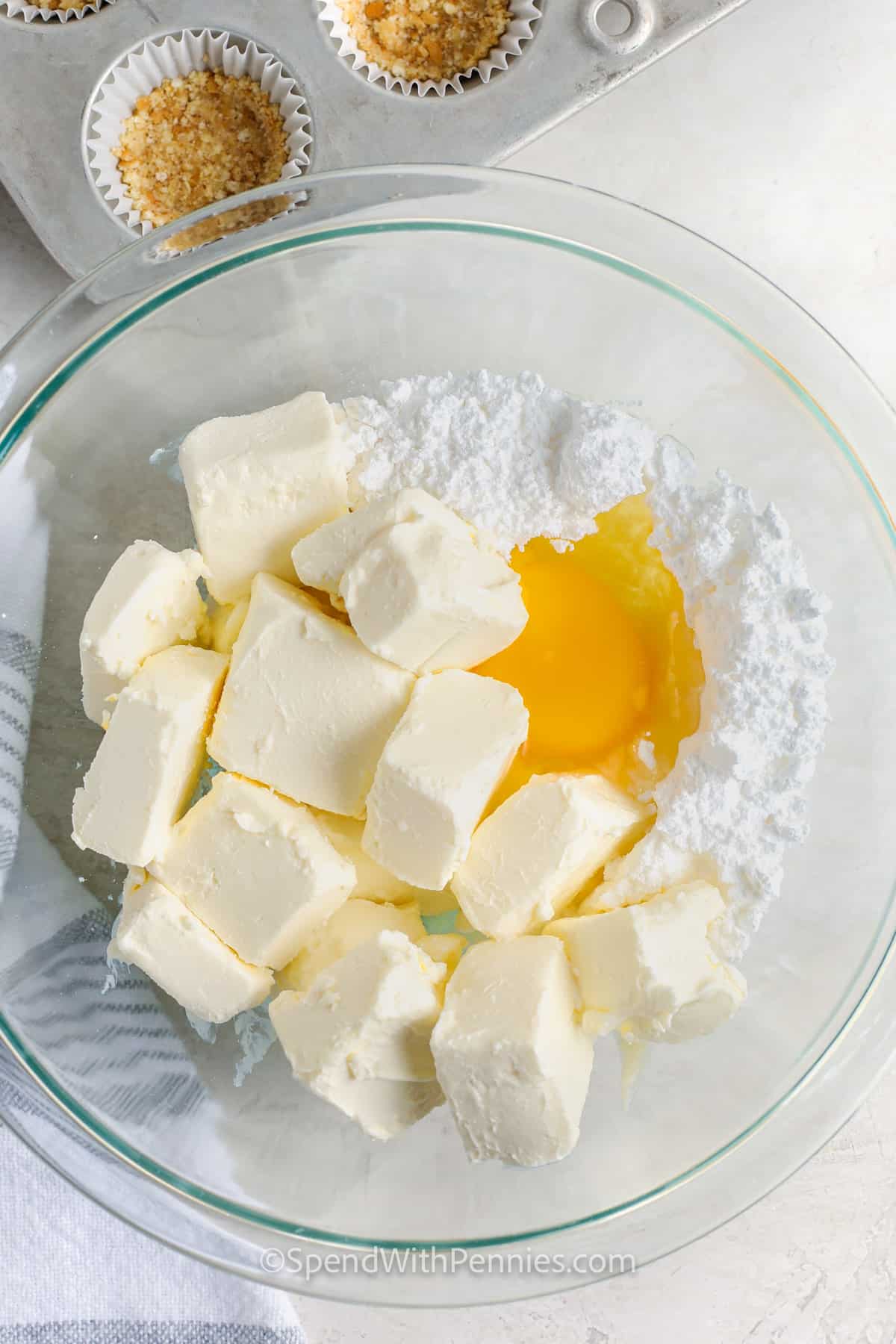 adding ingredients together to make Mini Cheesecakes filling