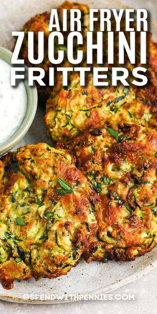Make some zucchini fritters for a healthy side dish with dinner tonight. Shredded zucchini, cheese, a little flour, bread crumbs, and an egg are mixed together and formed into patties. Then these healthy little fritters are fried until they are golden and crispy. Add in some shredded carrot, feta cheese, or shredded potato for a slight variation. #zucchinifritters #zucchinifrittersrecipe #healthyzucchinifritters #spendwithpennies air fryer zucchini fritters on a plate with text