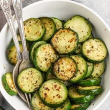 Sauteed Zucchini in a bowl work a fork and spoon