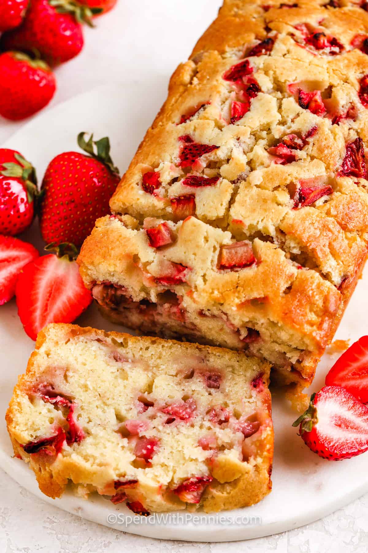 Strawberry bread is a moist and sweet quick bread recipe that is so easy to make and delish. This yummy Panera copycat recipe is sure to end up at the front of the recipe box. It's loaded with fresh strawberries and it tastes fantastic with cream cheese or butter. Serve it with a cup of coffee or tea for the best breakfast ever! #strawberrybread #recipeeasy #spendwithpennies #beststrawberrybread Strawberry Bread cut into slices