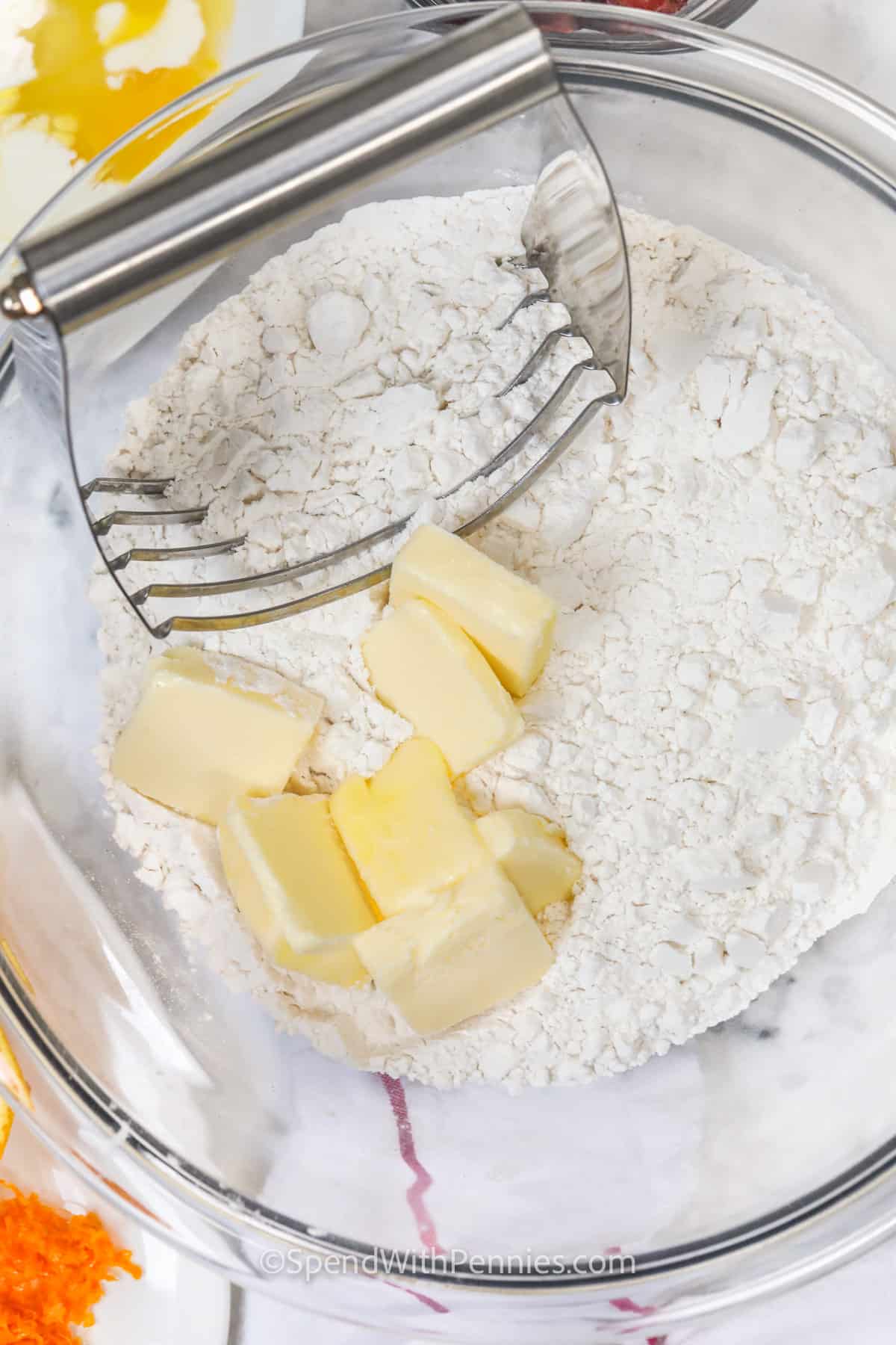 cutting butter with flour to make Cranberry Orange Scones