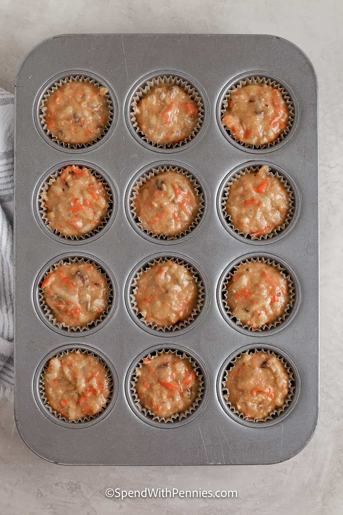 morning glory muffin batter in a muffin pan