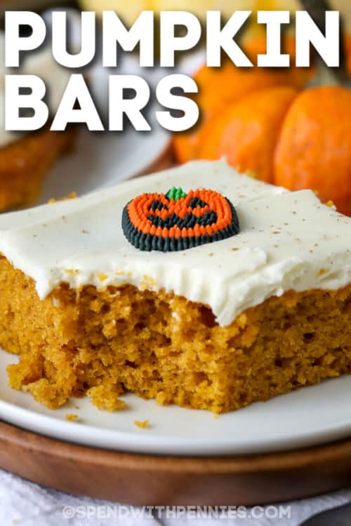 Easy pumpkin bars are luscious and moist, perfect with a steaming hot mug of coffee. These tasty little cakes will bring everyone to the table in a hurry. Easier to make than pumpkin cheesecake but just as delicious, these bars can also be frozen. Try them with whipped cream on top for a special treat. #pumpkinbars #pumpkinbarsrecipe #pumpkinbarswithcreamcheesefrosting #spendwithpennies plated Easy Pumpkin Bars with a title