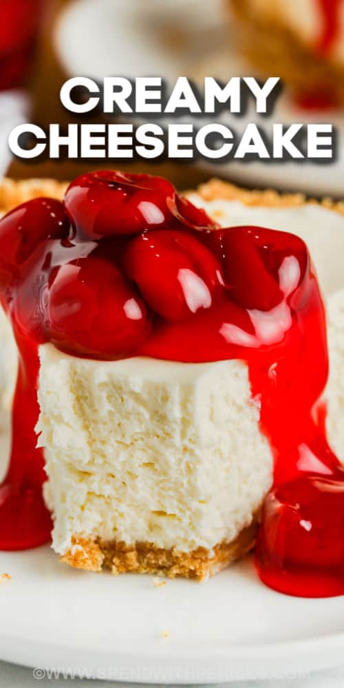 No-bake cheesecake keeps the oven free for other dishes, and it's the perfect make-ahead dessert. Luscious cream and cream cheese combine to make this decadent holiday treat. Top with fruit, chocolate, or serve it plain and let guests choose their favorite toppings. #nobakecheesecake #cheesecake #nobake #dessert #spendwithpennies close up of No Bake Cheesecake with a bite taken out and a title