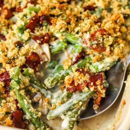 taking a spoonful of Bacon Green Bean Casserole out of the dish