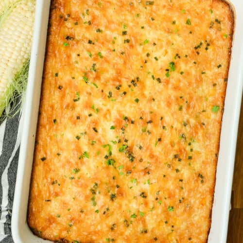 Corn pudding in a white casserole dish