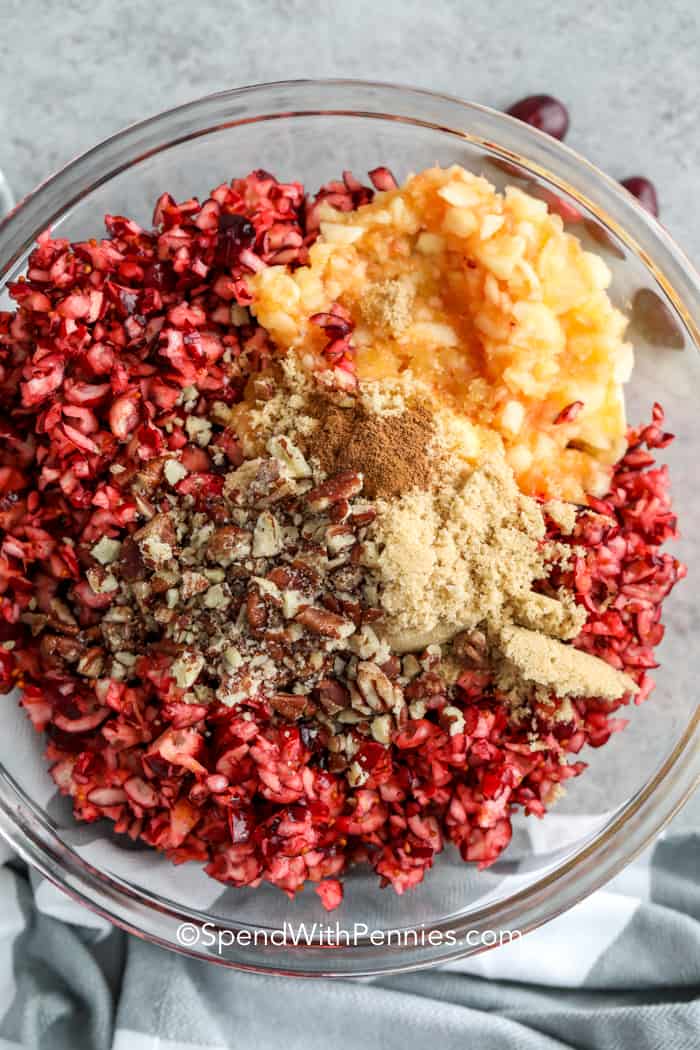 adding ingredients together in a bowl to make Zesty Cranberry Relish