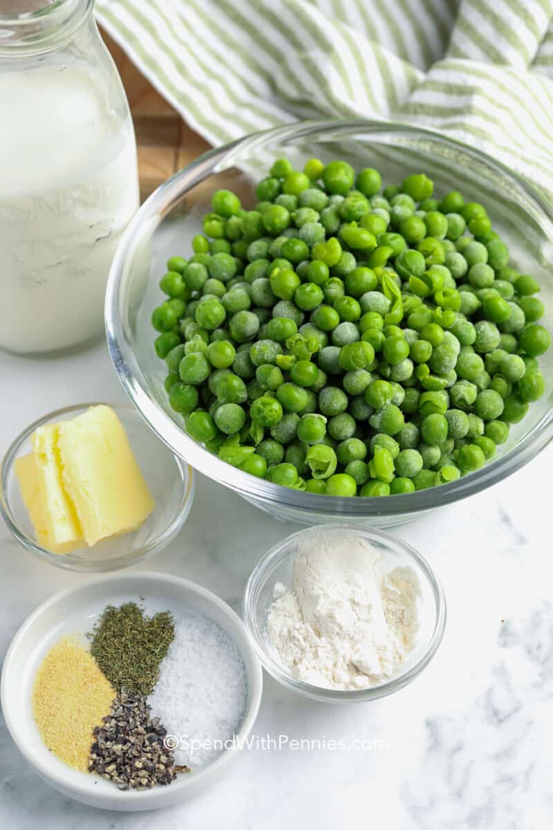 ingredients for creamed peas on a counter with a kitchen towel