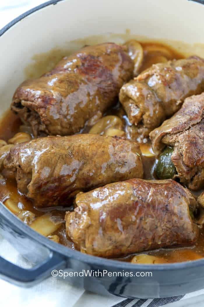 Rouladen is an old-fashioned flavorful entree! These delicious beef roll ups are made with thinly sliced beef bacon, onions, and a dill pickle! Serve with mashed potatoes and roasted veggies for the perfect meal! #spendwithpennies #rouladen #maincourse #beefrecipe cooking Beef Rouladen in sauce