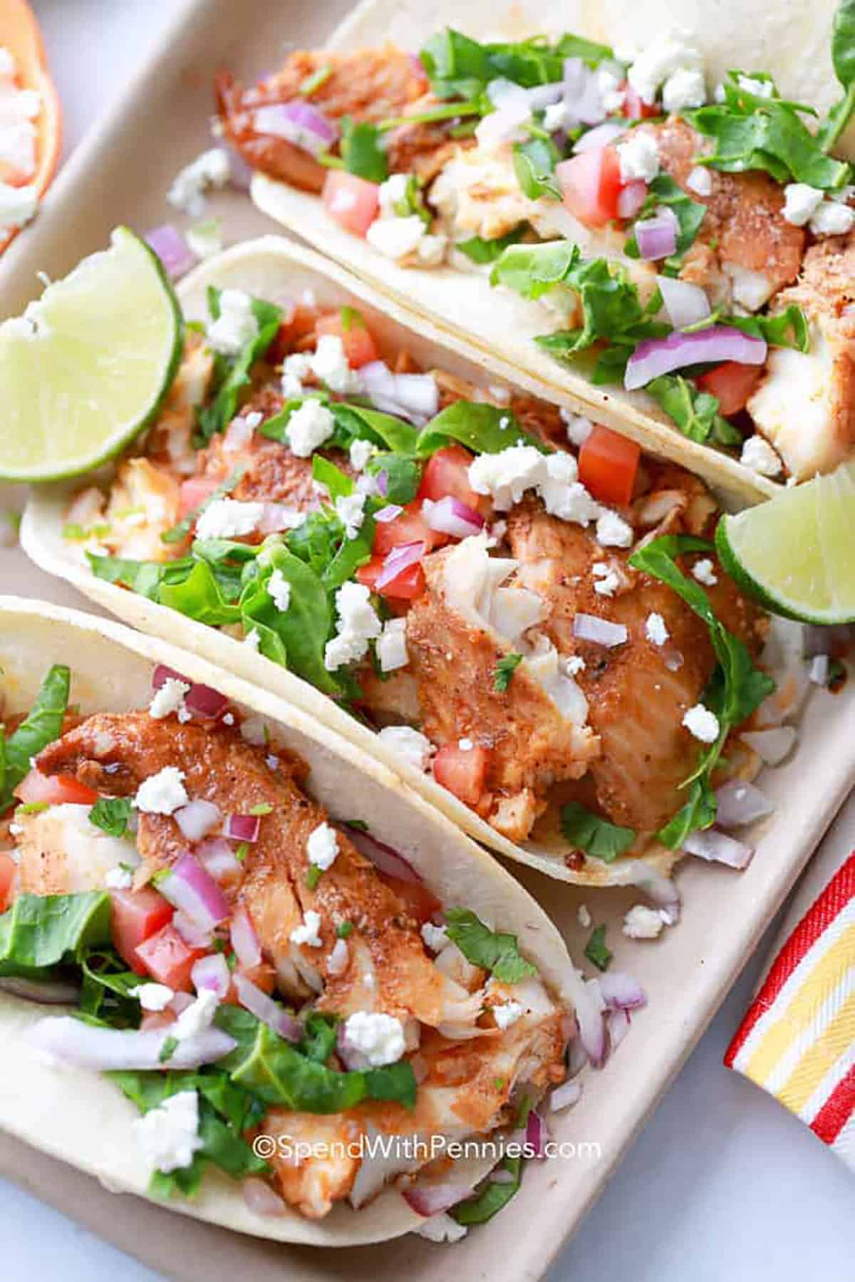 Easy Fish Tacos are the perfect weeknight meal. Light and fresh fish tacos are great for lunch, too! They go from fridge to table in about 20 minutes! Don't forget the homemade salsa and toppings. #fishtacos #easyfishtacos #tacos #spendwithpennies plated Easy Fish Tacos