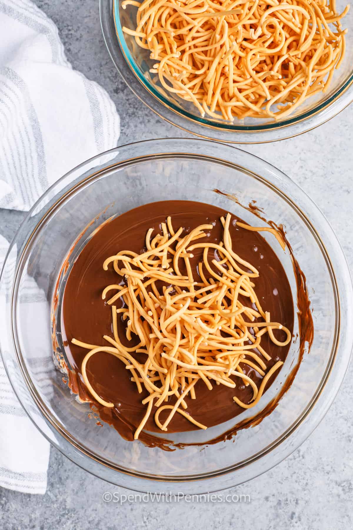 adding chow mein to melted chocolate to make Haystacks