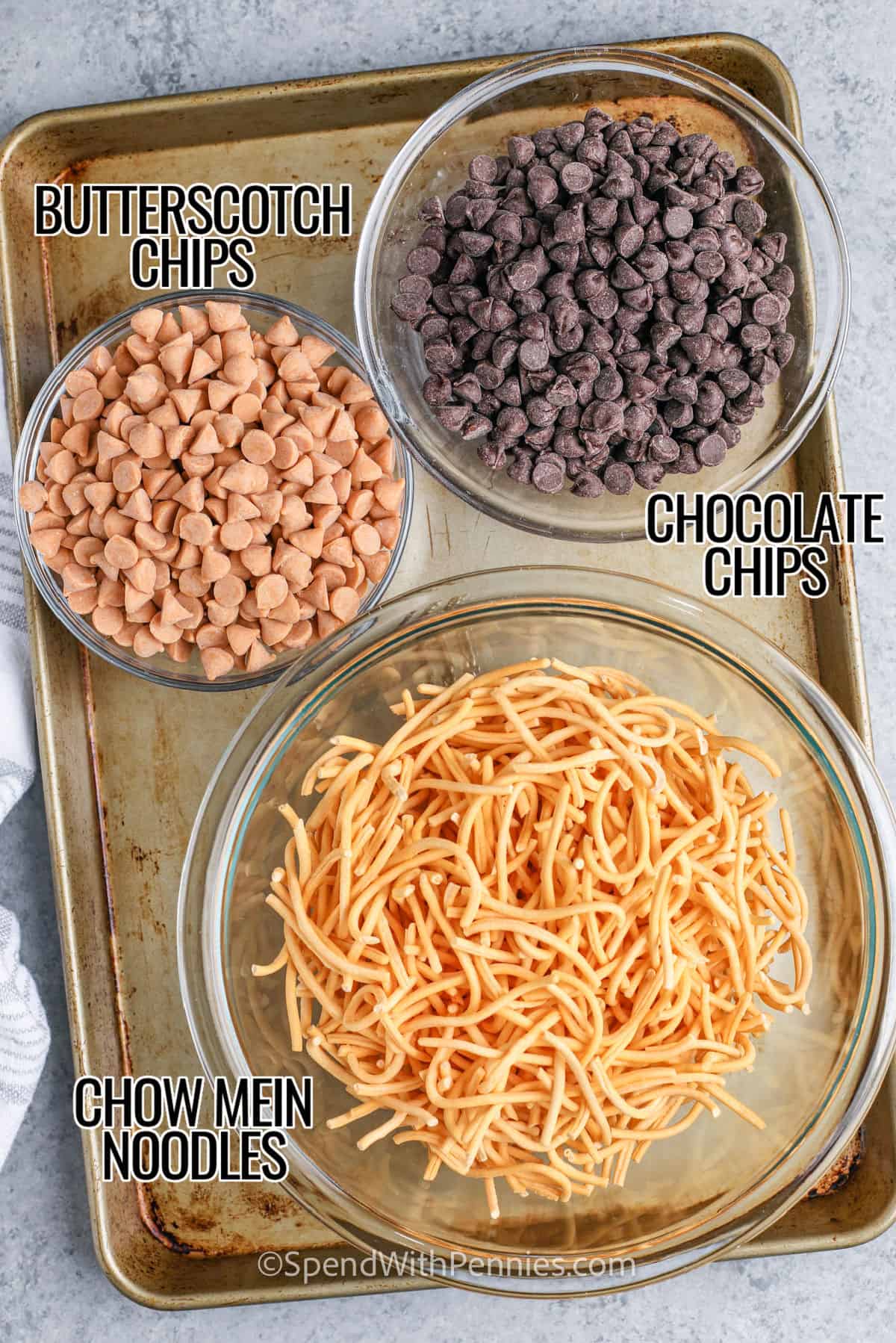 butterscotch chips , chocolate chips and chow mein noodles in bowls with labels to make Haystacks