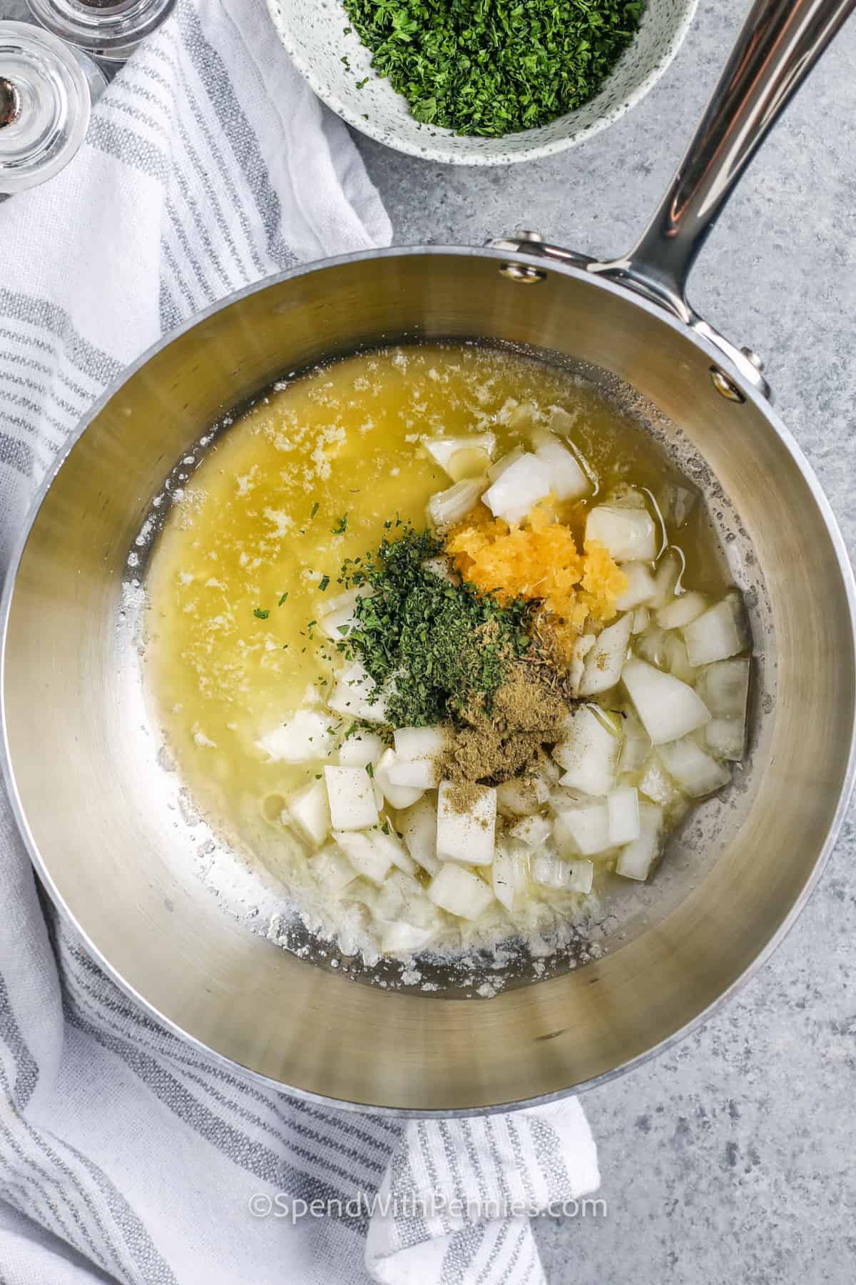 adding seasonings and onions to melted butter to make Turkey Noodle Casserole