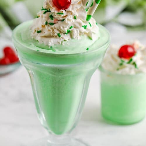 Copycat Shamrock Shakes in glasses with whipped cream and cherries