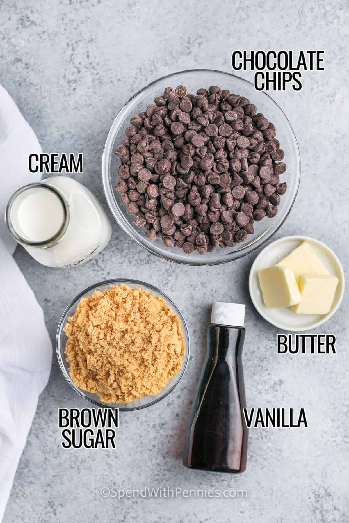 For a quick and easy hot fudge sauce, nothing beats this easy recipe! It's ready in 5 minutes and only has 5 simple ingredients! Everyone loves homemade hot fudge on brownies, cakes or sundaes! Try making this easy recipe and watch it magically disappear before your eyes! So easy, chocolaty and sweet. #homemadehotfudgesauce #easyhotfudgesauce #fudgesauce #spendwithpennies Chocolate chips, heavy cream, brown sugar, butter and vanilla with labels for making Hot Fudge Sauce
