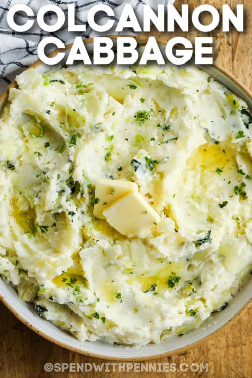 Colcannon is a traditional Irish dish consisting of cabbage and onion (or leeks) fried until tender and gently folded into rich and creamy mashed potatoes. It is the perfect dish for St. Patrick's Day (or any other day you're craving the best ever comfort food)! #colcannon #mashedpotatoes #cabbage #cabbageandbacon #spendwithpennies bowl of Colcannon Recipe with butter and a title