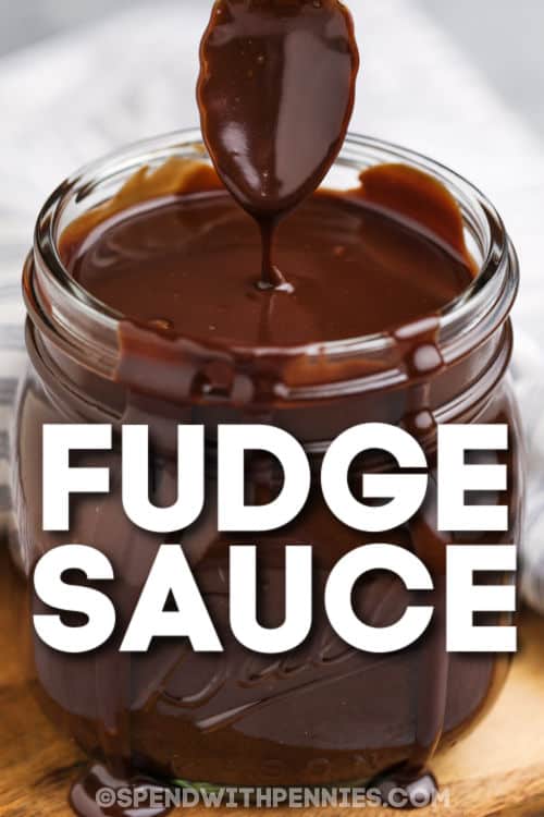 This easy hot fudge recipe is ready in 5 minutes and only has 5 simple ingredients! It's so easy to make on the stovetop. Homemade hot fudge sauce for sundaes is the best! Skip the McDonald's drive-thru and make this delicious recipe at home in minutes. It tastes better without preservatives and additives. This recipe is thick, sweet, and delicious. #homemadehotfudgesauce #easyhotfudgesauce #fudgesauce #spendwithpennies Close up of a jar of fudge sauce with a title