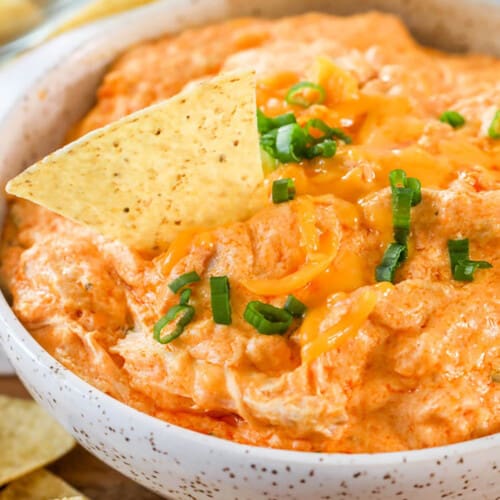 Crockpot Buffalo Chicken Dip in a bowl with a chip