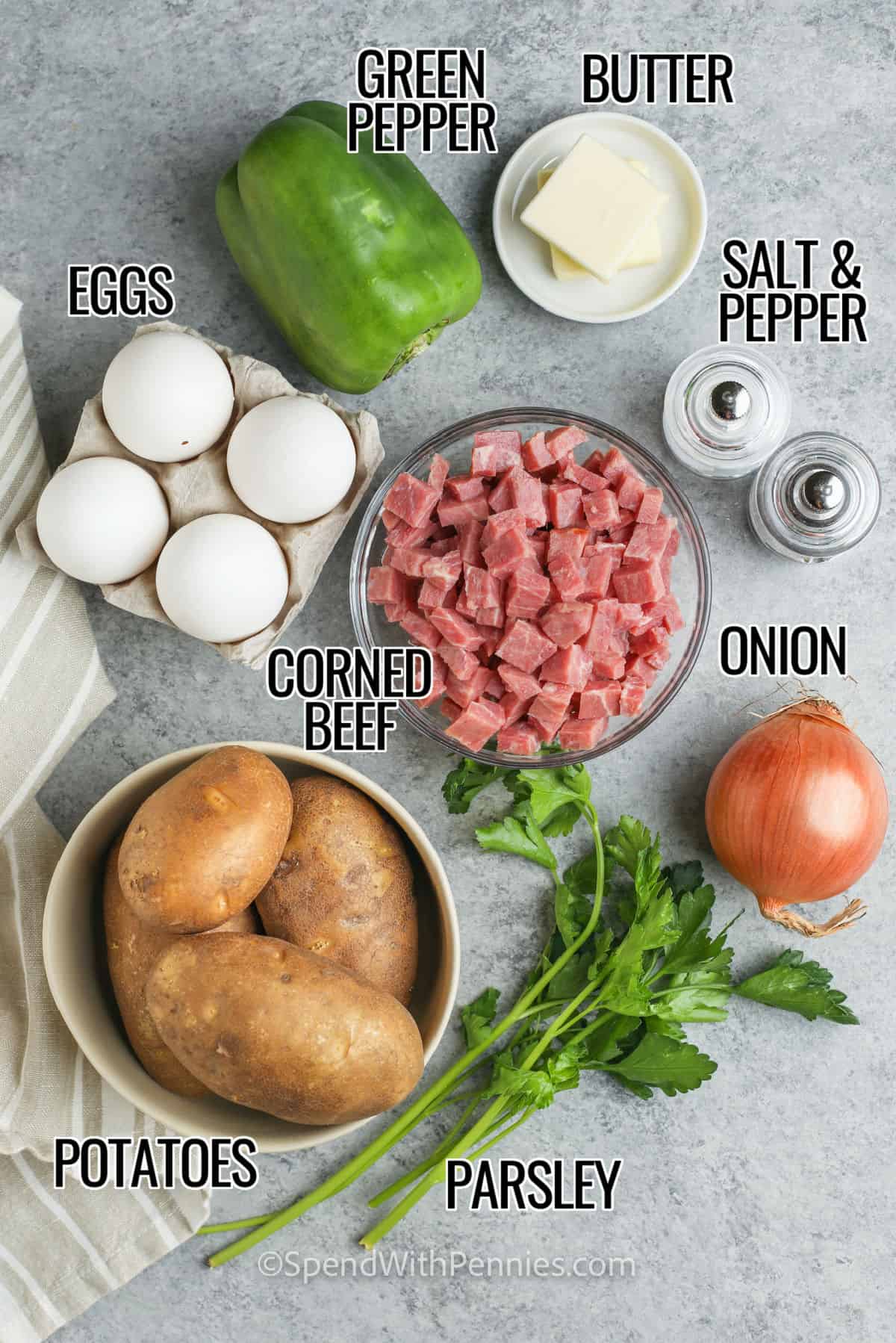 Corned beef hash and eggs is a one-pan recipe that makes leftovers taste brand new. Diced corned beef warms through and gets lightly crisp while the potatoes brown in butter for a golden crust. Onion and green pepper add sweetness and bite. Finish in the oven so the eggs cook evenly without fuss. This corned beef hash recipe is cozy, filling, and great for breakfast, brunch, or dinner with minimal cleanup. #spendwithpennies butter , green pepper , eggs , salt and pepper , corned beef , onion , potatoes and parsley with labels to make Corned Beef Hash