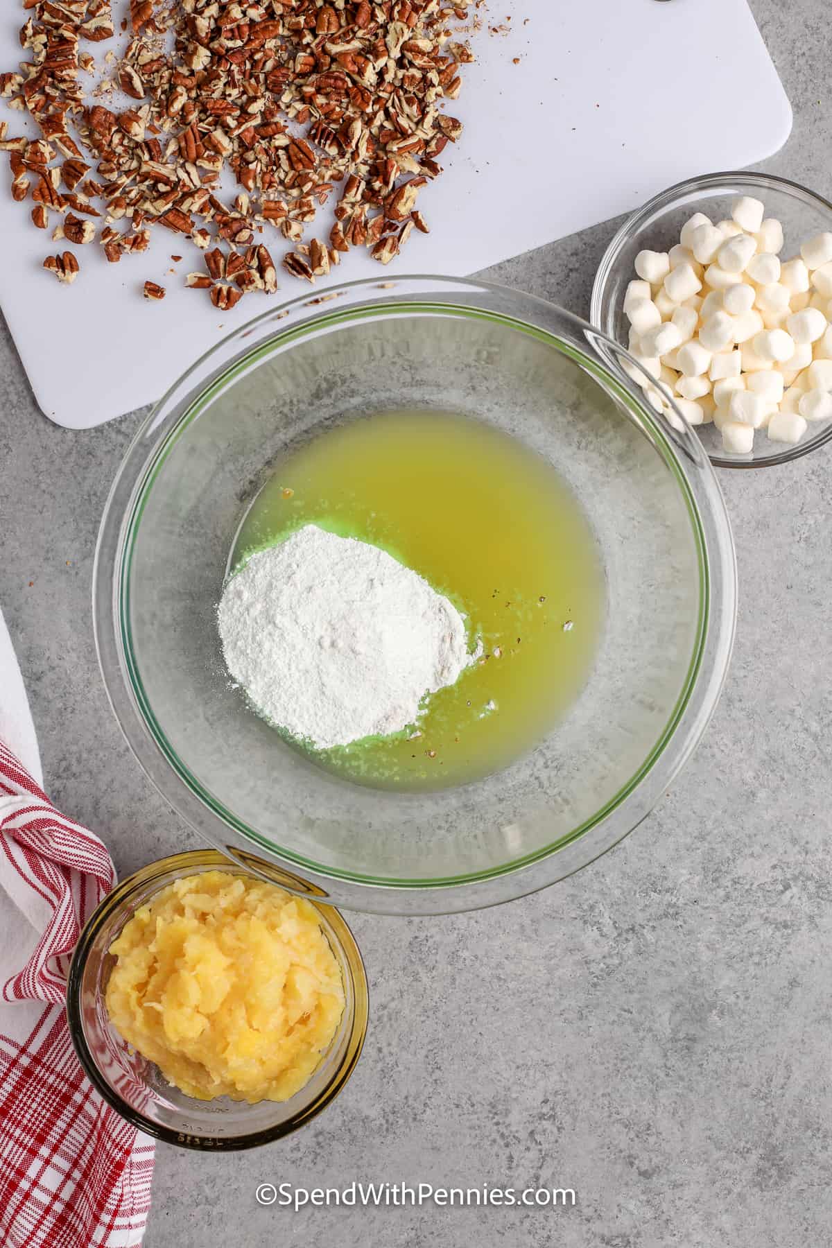 Watergate salad is a colorfully unique addition to any table! This family favorite recipe is just the way Grandma used to make it. Everyone will love this delicious dish, whether it's served as a side dish or dessert! #watergatesalad #dessert #sidedish #recipe #spendwithpennies ingredients for watergate salad in seperate bowls
