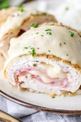 chicken cordon blue cut in half on a plate