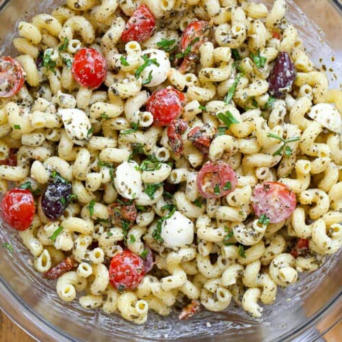 A large bowl of pesto pasta salad