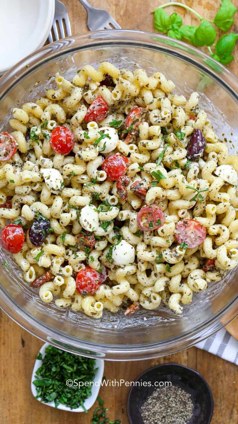 A large bowl of pesto pasta salad