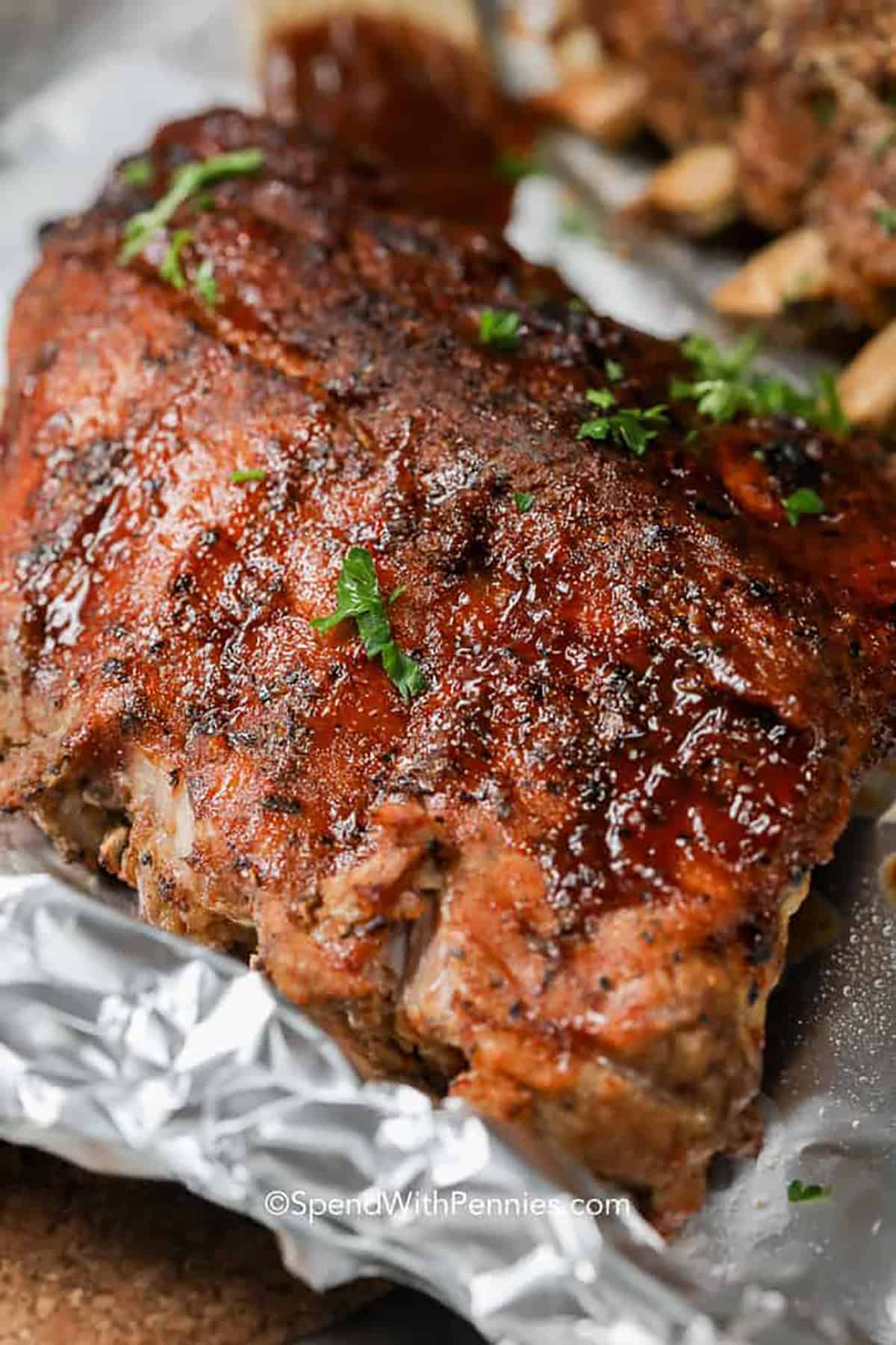 Instant Pot Ribs are the perfect way to make tender juicy baby back ribs. We slather them in BBQ sauce for extra flavor! #spendwithpennnies #ribs #instantpot #instantpotrecipe #instantpotribs #maincourse cooked Instant Pot Ribs in foil