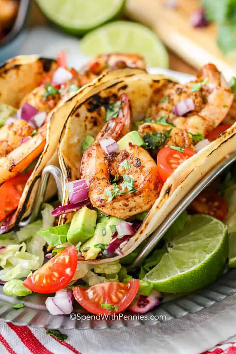Shrimp tacos are a delicious way to enjoy fresh ingredients. These flavorful shrimp tacos are ready in a matter of minutes, making them perfect for a quick weeknight dinner! #shrimptacos #tacos #shrimp #spendwithpennies plated Shrimp Tacos