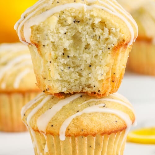 stack of Lemon Poppy Seed Muffins with a bite taken out of one