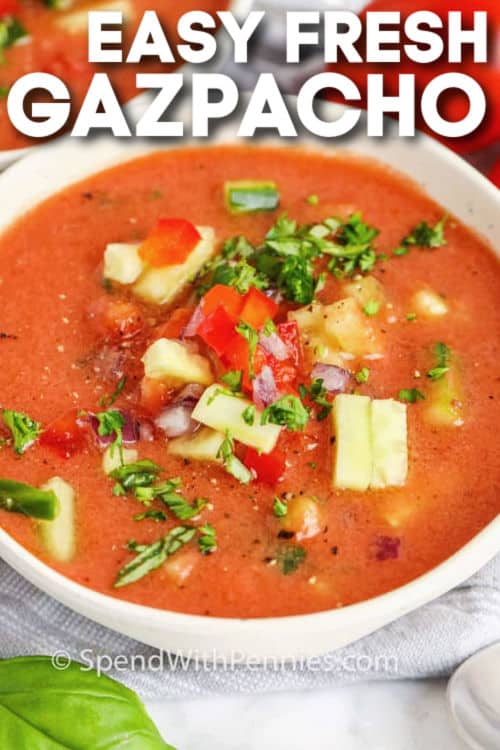 Gazpacho soup is easy to make and very refreshing in the summer. Cold soup made from tomatoes, chopped vegetables and spices is a traditional Spanish custom. It can also be made into a sweet, chilled soup with cucumber and watermelon. It's delicious and nutritious and always a favorite on a hot day. #gazpachorecipe #easycoldsouprecipe #bestspanishrecipe #spendwithpennies Simple fresh gazpacho in bowls with writing