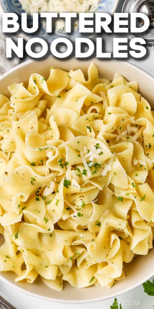Make buttered noodles part of the menu rotation! This pasta recipe is so versatile and can be seasoned to taste with hot peppers or extra cheese. Add in what’s on hand like leftover meat or vegetables for extra nutrition. Similar to cacio e pepe, this buttered noodles dish is an easy classic that kids and grownups both love. #butterednoodles #butterednoodlesrecipe #easyspaghetti #spendwithpennies Buttered Noodles in a bowl with garnish and a title