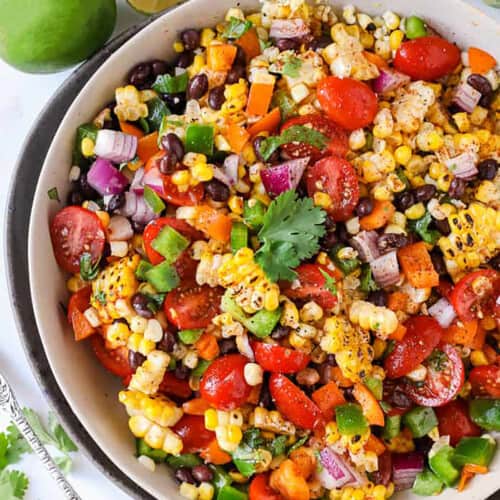 bowl of Black Bean and Corn Salad with limes