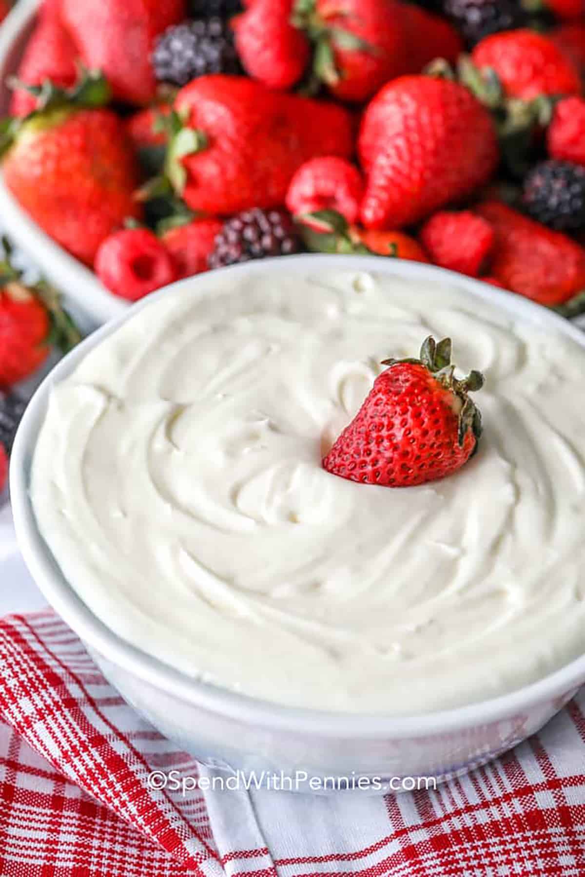 Immerse yourself in the deliciousness of a two-ingredient fruit dip that brings out the best in your favorite fruits. It's an easy and filling way to enjoy a sweet and creamy snack. Serve with a fruit tray, cookies or waffles! #fruitdip #2ingredientfruitdip #dessert #dip #spendwithpennies Fruit dip with berry peel