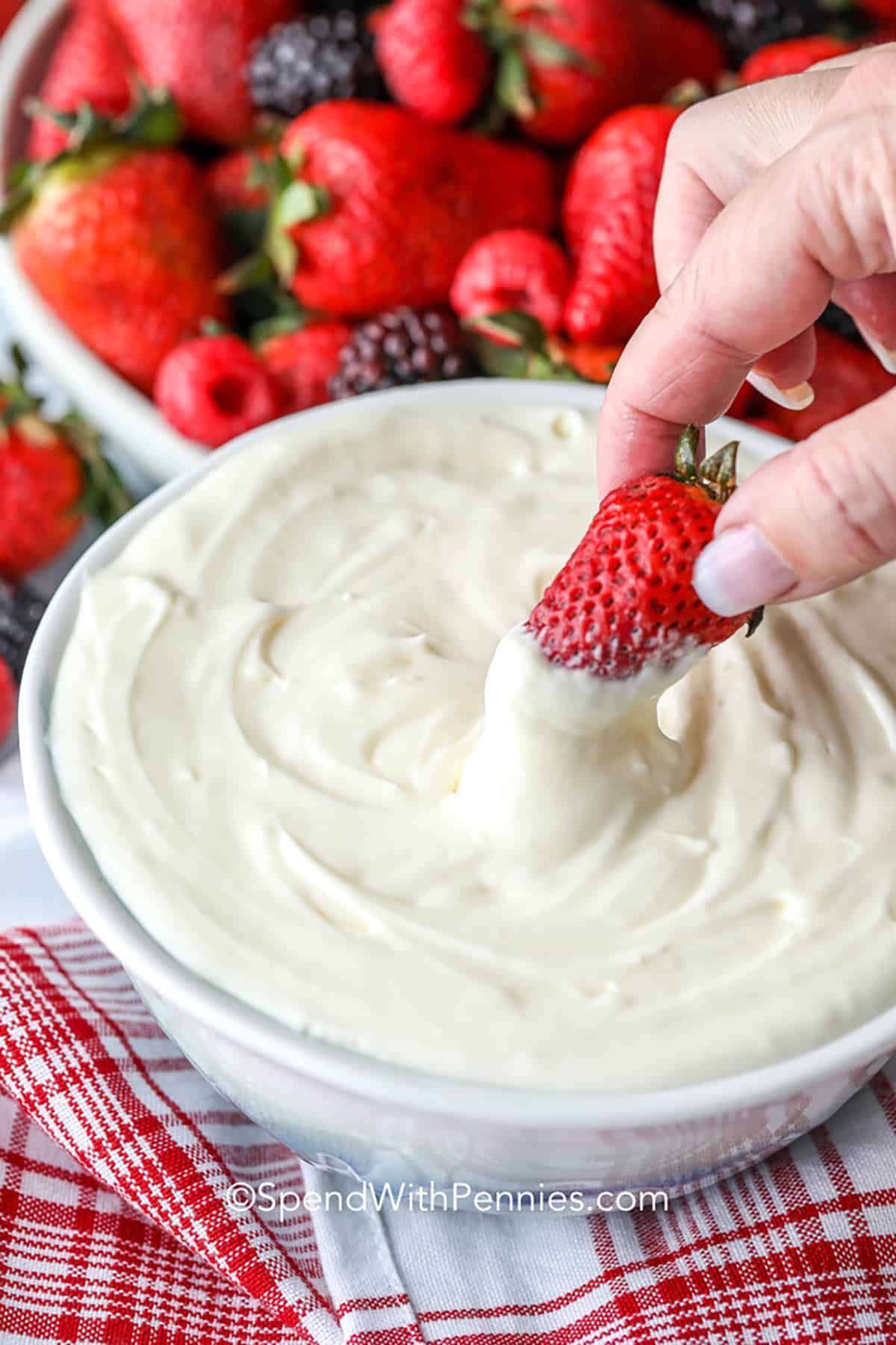 Treat your taste buds to a two-ingredient fruit dip that transforms simple fruit into a delicious and flavorful treat. It's a fun and easy way to enjoy a healthy snack. Serve with fresh fruit or even cookies! #fruitdip #2ingredientfruitdip #dessert #dip #spendwithpennies Dip strawberries in fruit dip