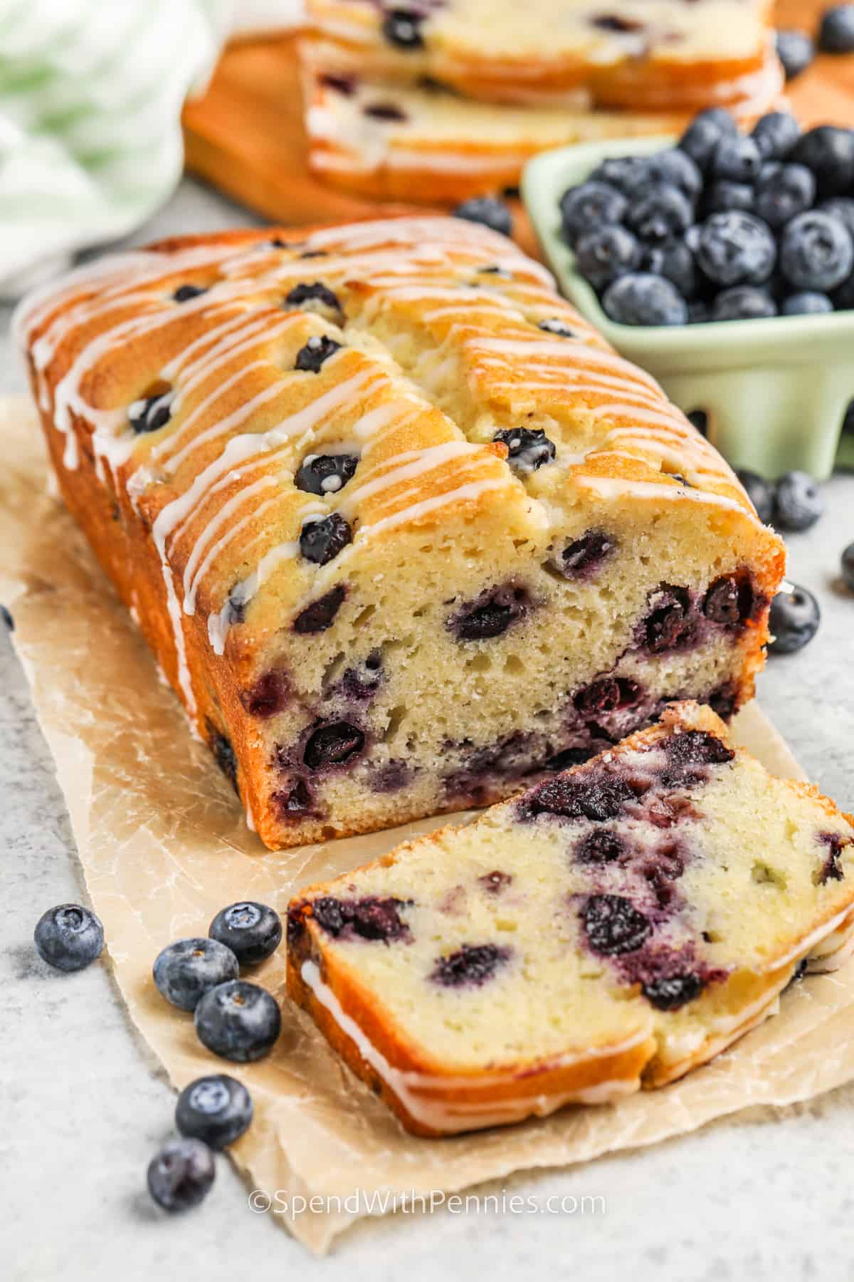 This quick blueberry bread recipe is so easy to make and it comes out with the best moist texture. Load it up with plenty of healthy blueberries and enjoy it with that morning yogurt. Cream and lemon juice give this bread an amazing flavor and some extra tang. Enjoy it with a cup of coffee for a special breakfast treat. #blueberrybreadrecipe #easyblueberrybread #bestblueberrybread #spendwithpennies Blueberry Bread with a slice taken out