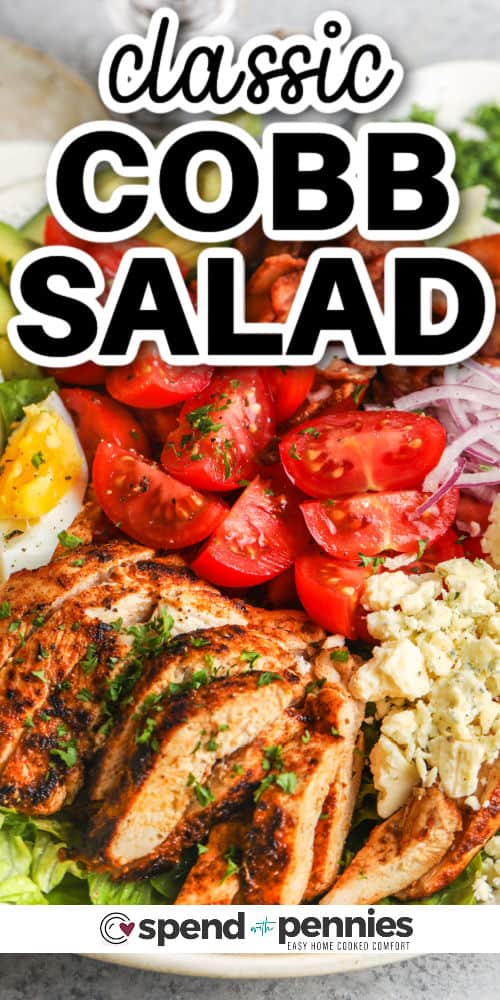 Try making a delicious Cobb salad for an easy and delicious entree that's sure to please. Loaded with chicken and cheese, romaine lettuce, avocado, eggs, and tomatoes in a creamy homemade dressing, it's easy to substitute components, too. Don't forget the crispy bacon or add in some crispy croutons. This filling salad is sure to please whether served as a light dinner-time entree or a hearty lunch. #cobbsalad #cobbsaladrecipe #salad #recipe #spendwithpennies close up of Cobb Salad on a plate with a title