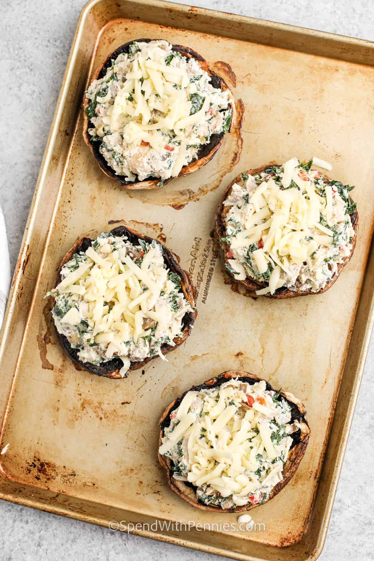 unbaked Stuffed Portobello Mushrooms on a baking sheet