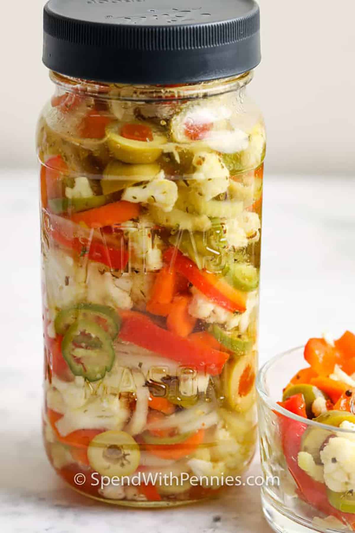 Giardiniera is a delicious combination of fresh veggies, pickled with spices until flavors blend. It can be made spicy or mild, depending on how many spices are added! #giardiniera #condiment #italian #spendwithpennies jar of Giardiniera