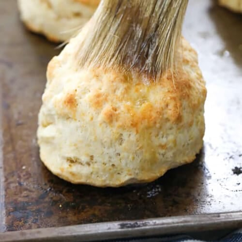brushing butter on Homemade Biscuits